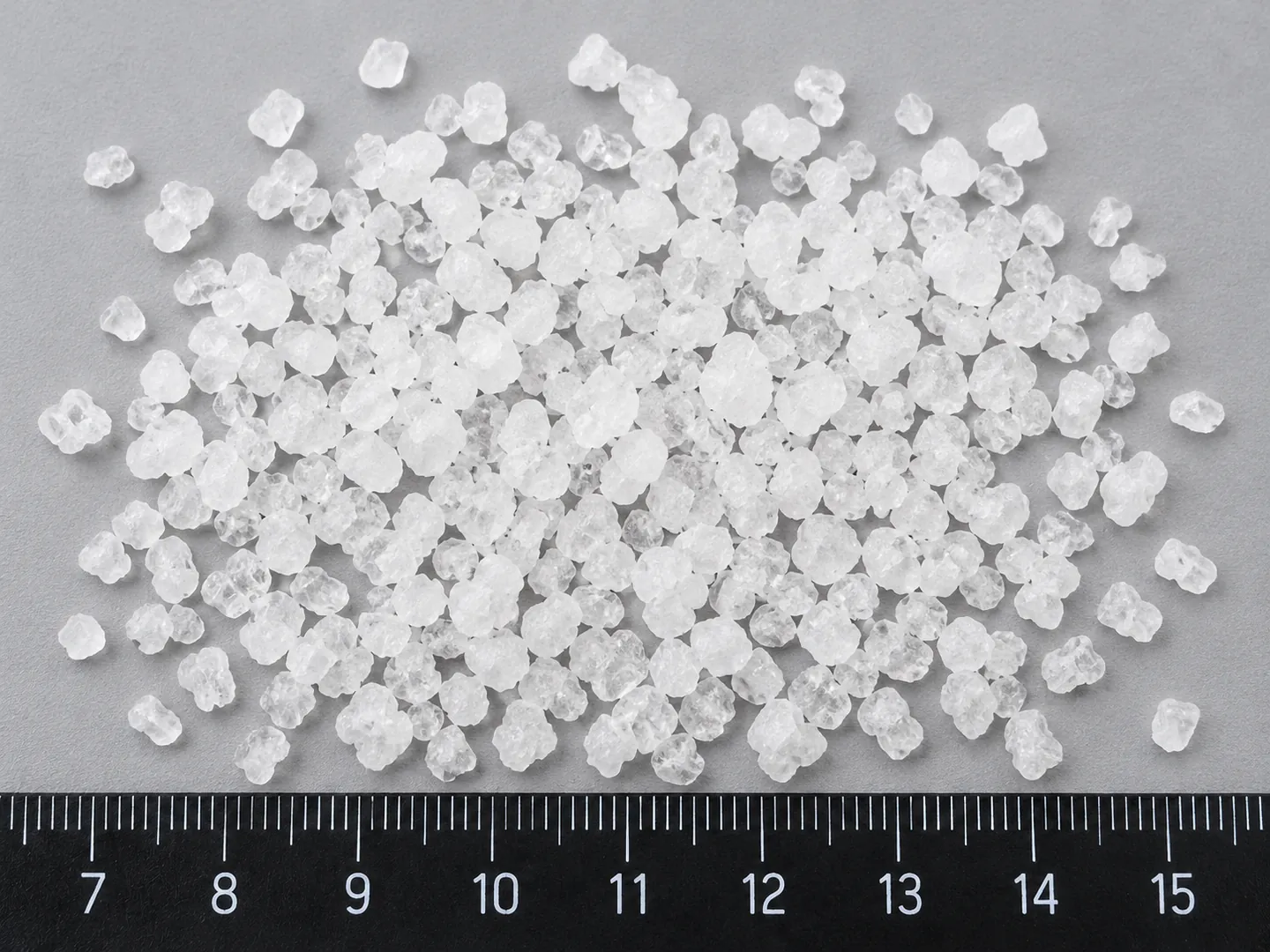 Extra-Refined Coarse sea salt crystals beside a ruler, 2–4 mm fraction
